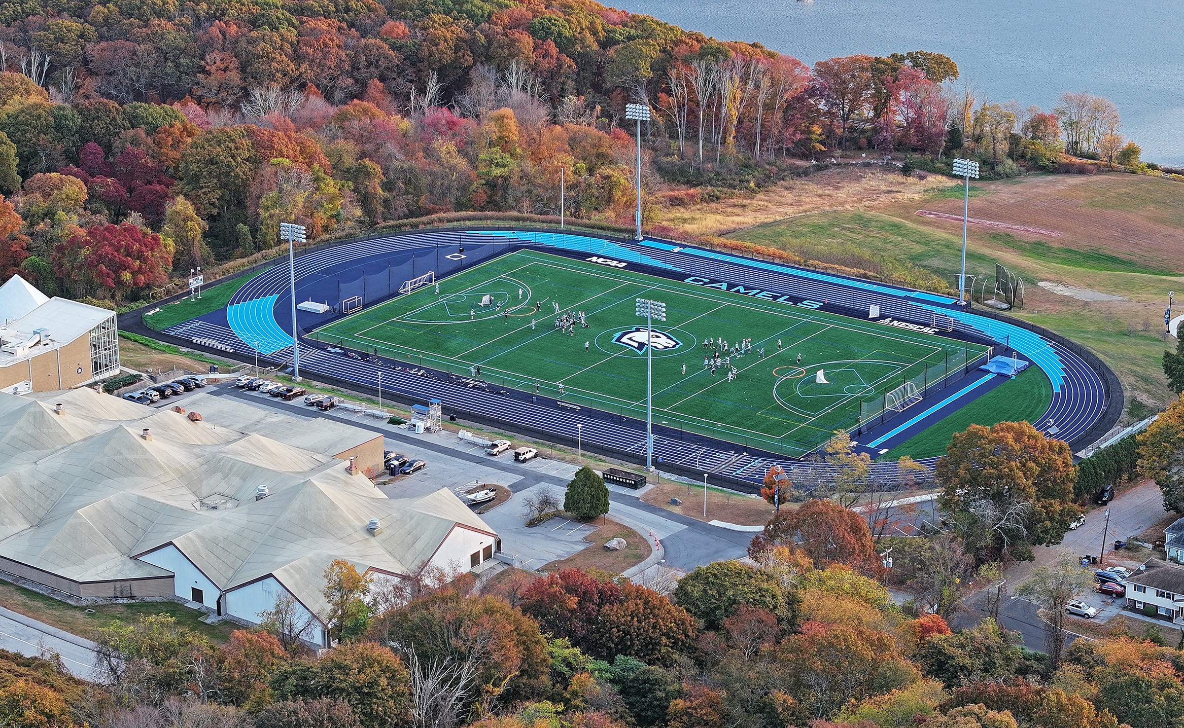 Aerial view as a lacrosse team practices on a newly renovated turf field.