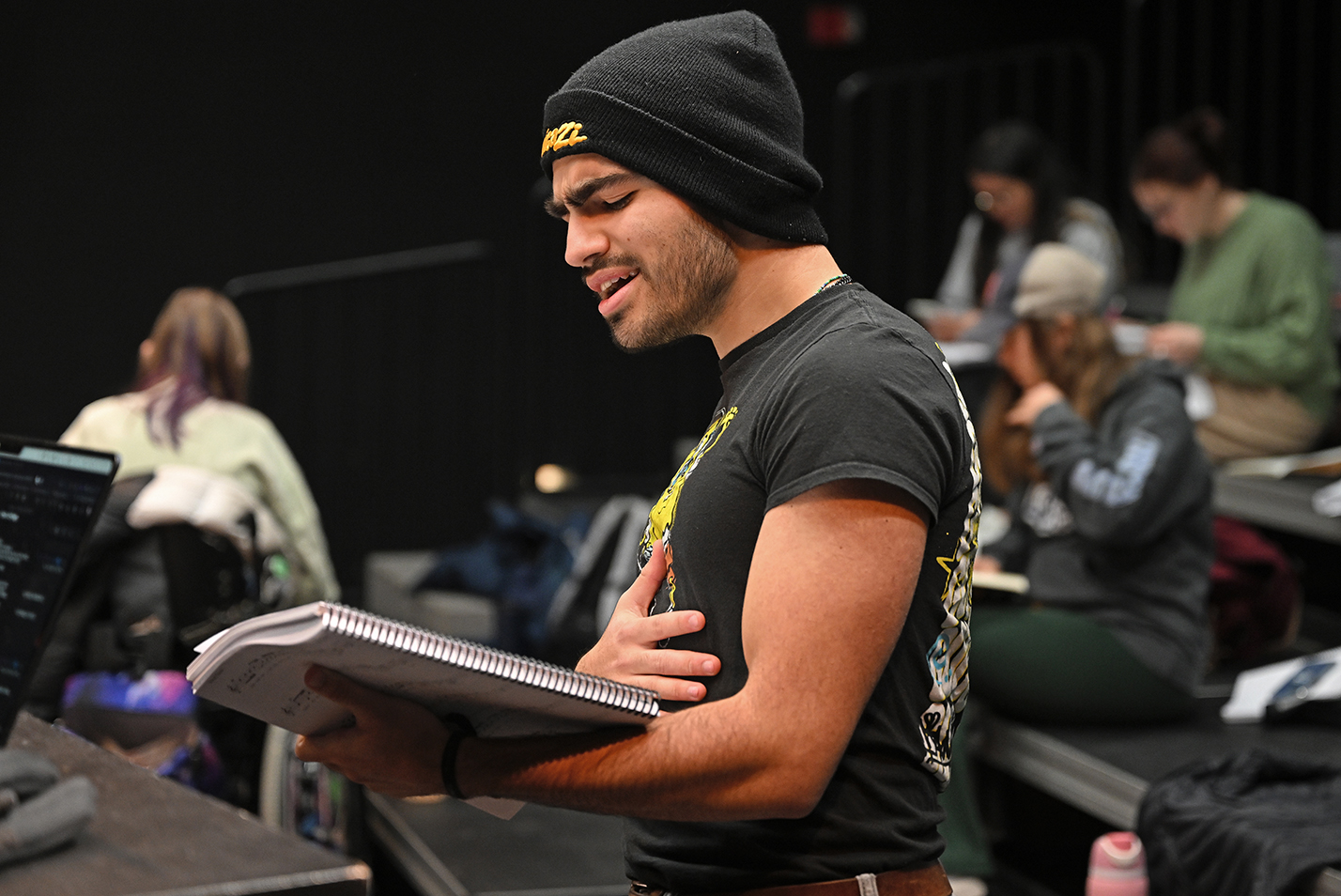 An actor practices his vocal part during a musical theater rehearsal.